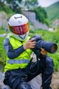 Person in Yellow and Black Jacket Holding Black Dslr Camera