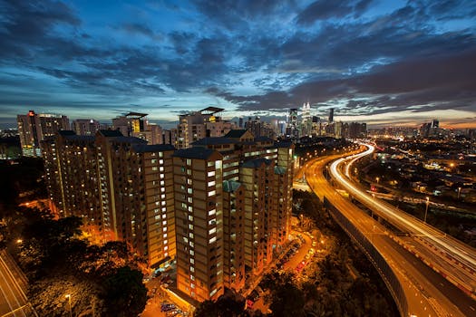 Stunning night view of Kuala Lumpur's illuminated skyline with dynamic highway lights.