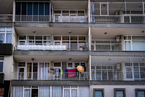 An Apartment Building with Balconies and Glass Windows