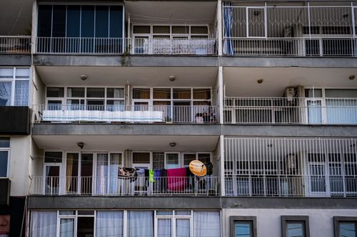 Free Low angle view of a modern apartment building showcasing balconies and glass windows. Stock Photo