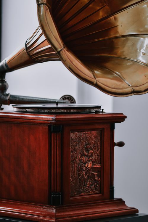 Free Close-up of a vintage brass gramophone with ornate wooden base, perfect for antique decor. Stock Photo
