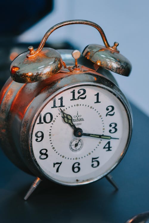 Free A Vintage Alarm Clock on the Table Stock Photo