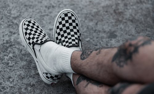 Person Wearing Black and White Checkered Shoes