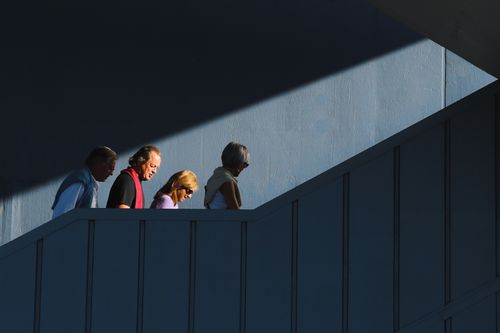 Free A group of people ascend a staircase under dramatic lighting in Istanbul. Stock Photo