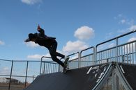 Man in Black Jacket and Black Pants Using Skateboard on Ramp