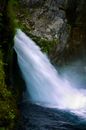 Waterfalls Between Green Moss Covered Rocks