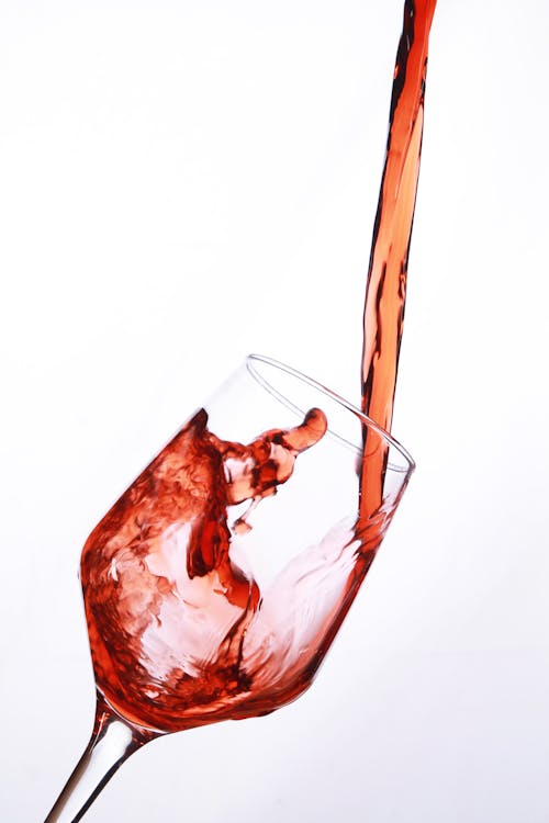 Free Red Wine Being Poured Into a Clear Glass Stock Photo