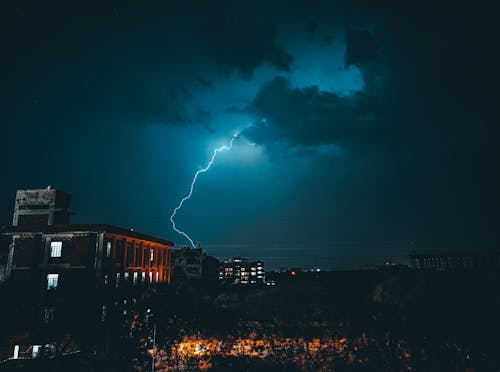 Lighting strikes over City During Night Time