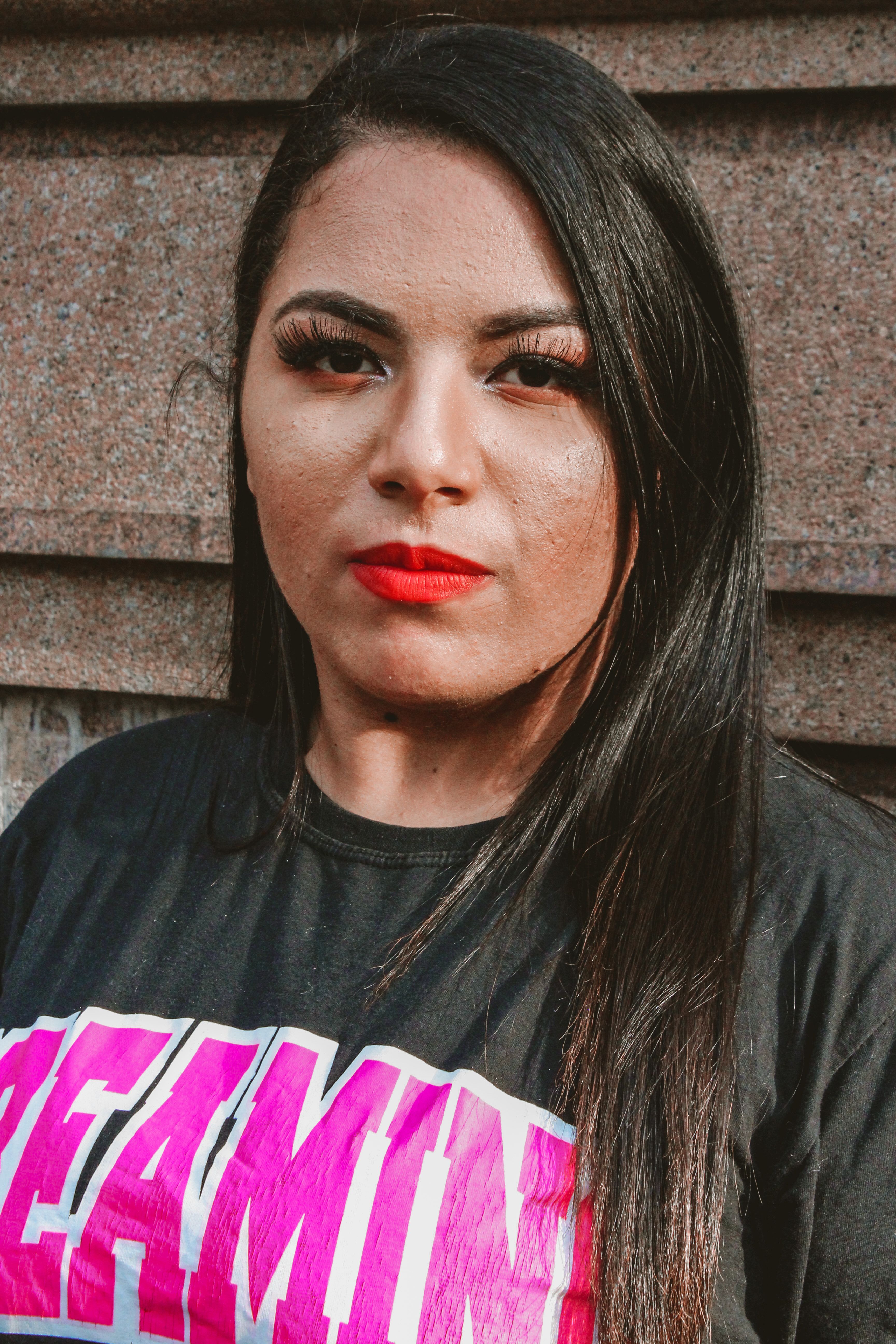 Empowering portrait of a woman with vibrant red lips in São Paulo, showcasing confidence and style.