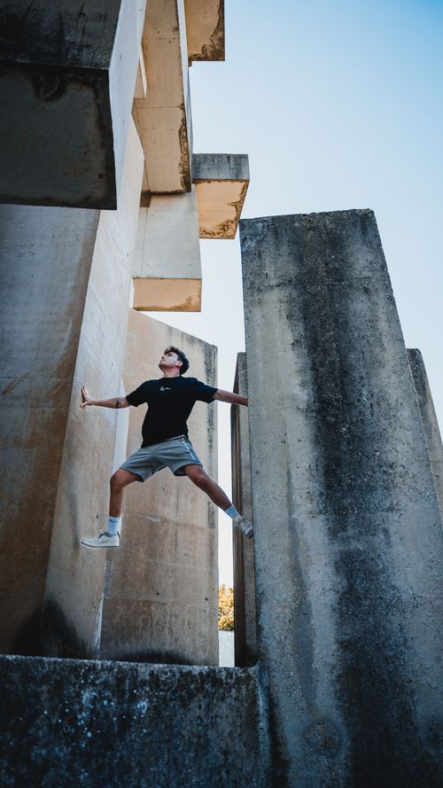 Free Dynamic shot of a man climbing concrete structures in Vienna, Austria. Stock Photo