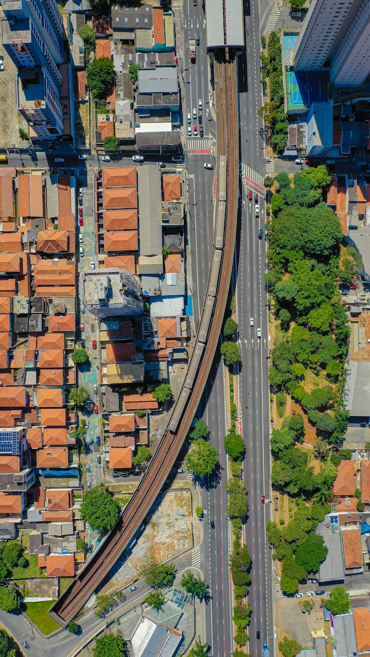 Drone Shot Of A Cityscape With Train Tracks