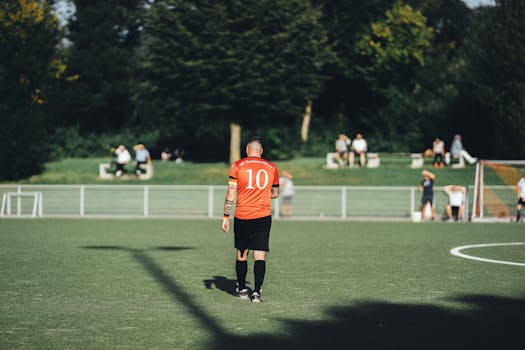 Back view of a football player wearing number 10 on a sunny day.