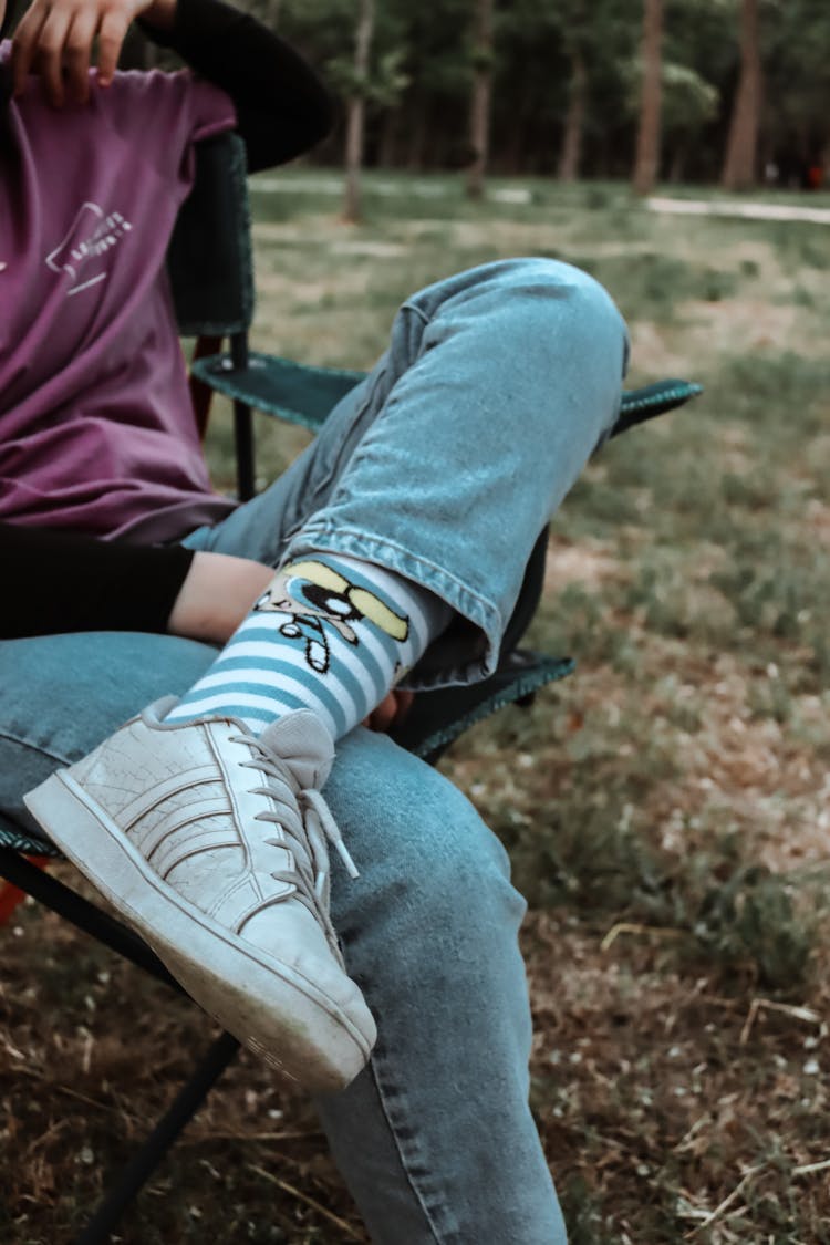 Photo Of A Sitting Person With Crossing Legs