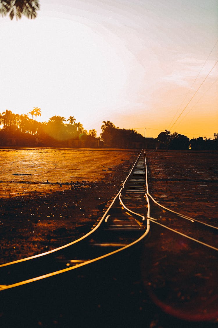 Photo Of A Train Tracks At Sunset