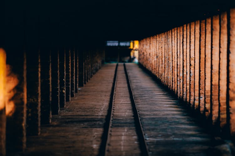 Photo Of A Tracks In Dark Tunnel