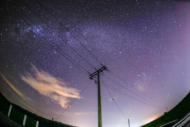 Electricity Lines Against Starry Night Sky