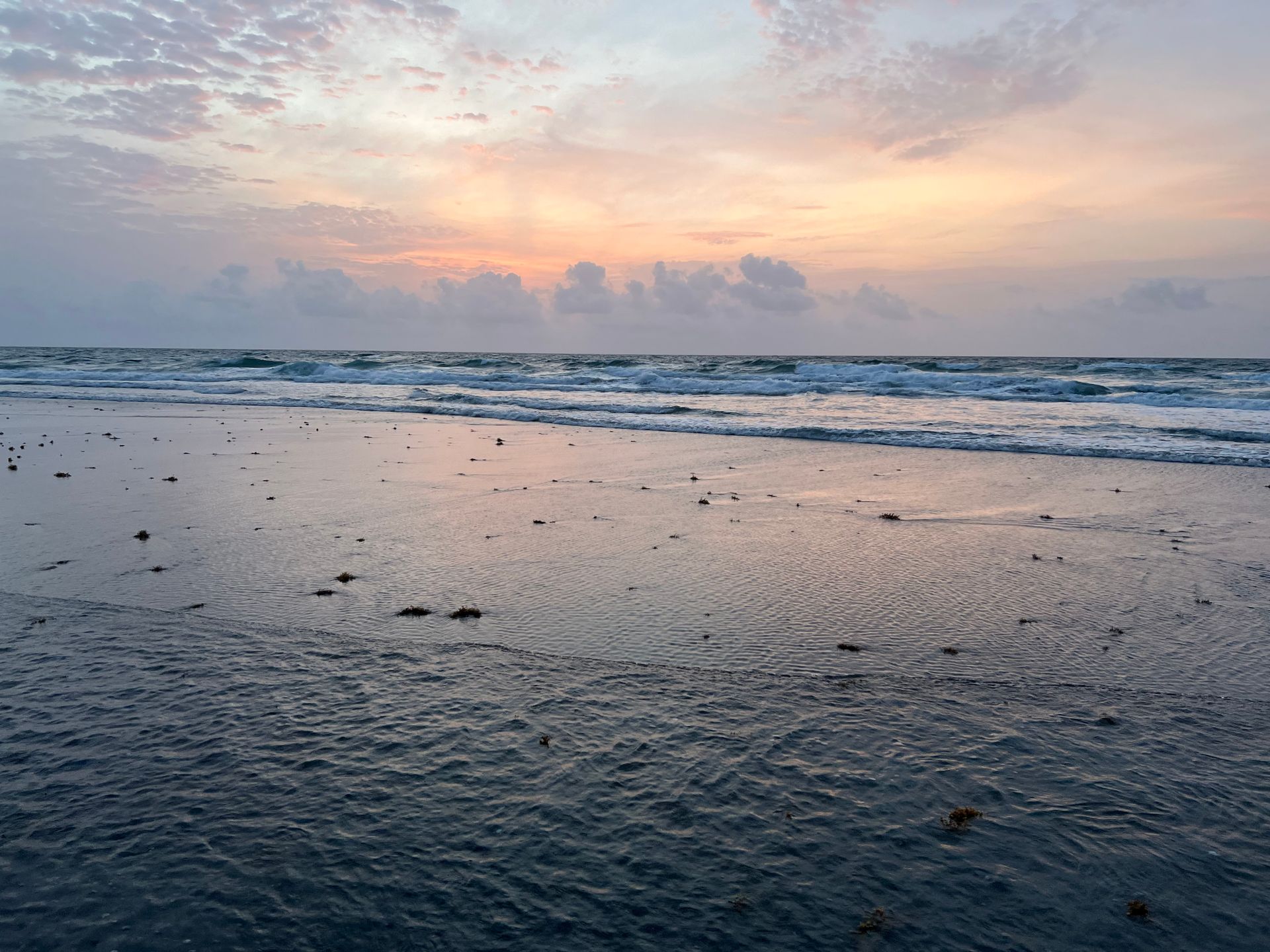 Serene sunset over the ocean at Boca Raton, Florida, with waves and a pastel sky creating a peaceful scene.