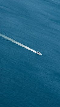 Dynamic aerial shot of a speedboat cruising through blue waters of Istanbul, Turkey.