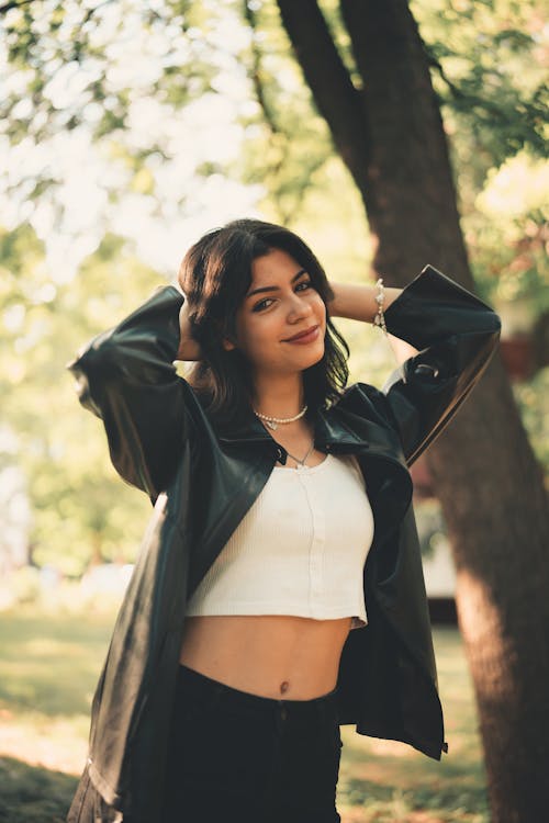 Woman in Black Jacket Standing Near Tree