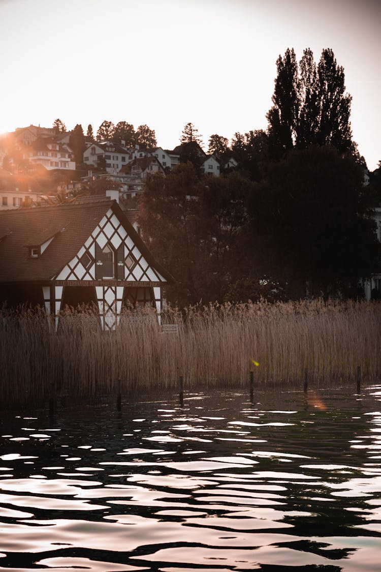 Brown Wooden House Near A Placid Lake