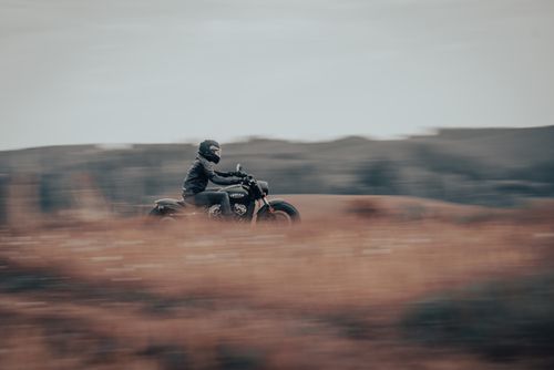 Free A motorcyclist rides swiftly through a scenic countryside, capturing the essence of adventure and freedom. Stock Photo