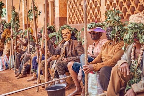 Group of People  Wearing Face Paint with Plants on Head