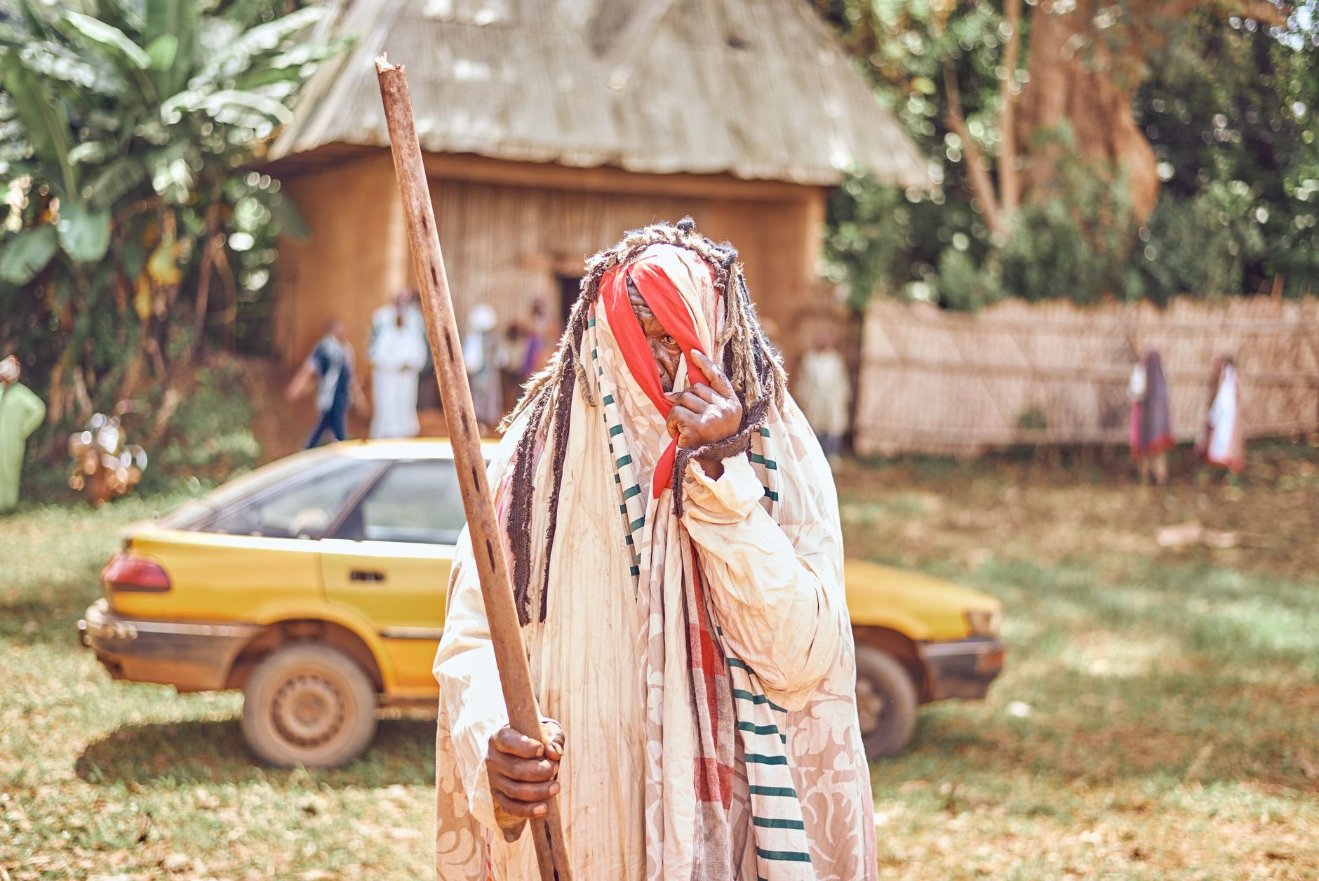 A vibrant depiction of traditional African tribal attire during a festival in Batoufam, Cameroon.