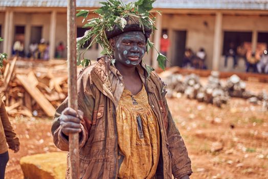 A tribal member in traditional attire and face paint during a ritual in Cameroon.