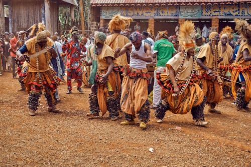 Free People in Traditional Dress Dancing on Brown Field Stock Photo