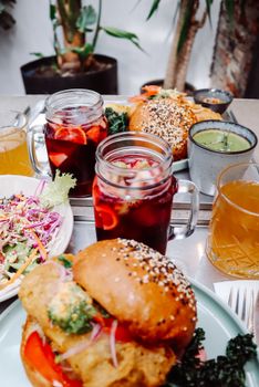 Colorful meal featuring gourmet burgers, sangria, and salad in an indoor dining setting in Santiago, Chile.