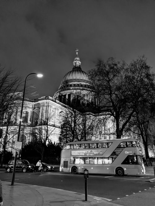 Free Black and white night shot of St Paul's Cathedral and a double-decker bus in London. Stock Photo