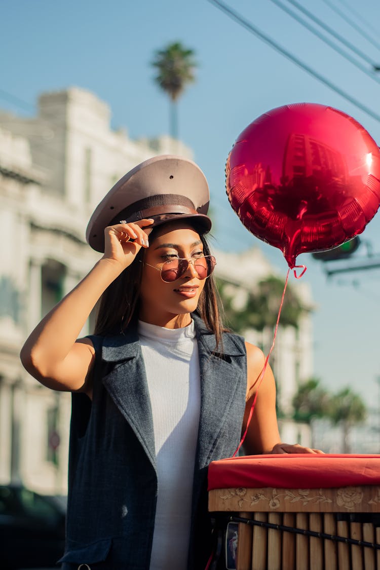 A Woman Wearing Cap And Sunglasses