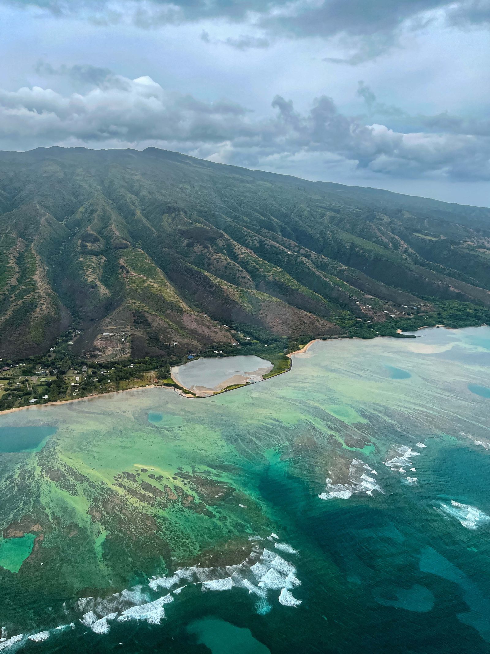 Maui coastline aerial with volcanic cliffs and deep blue Pacific