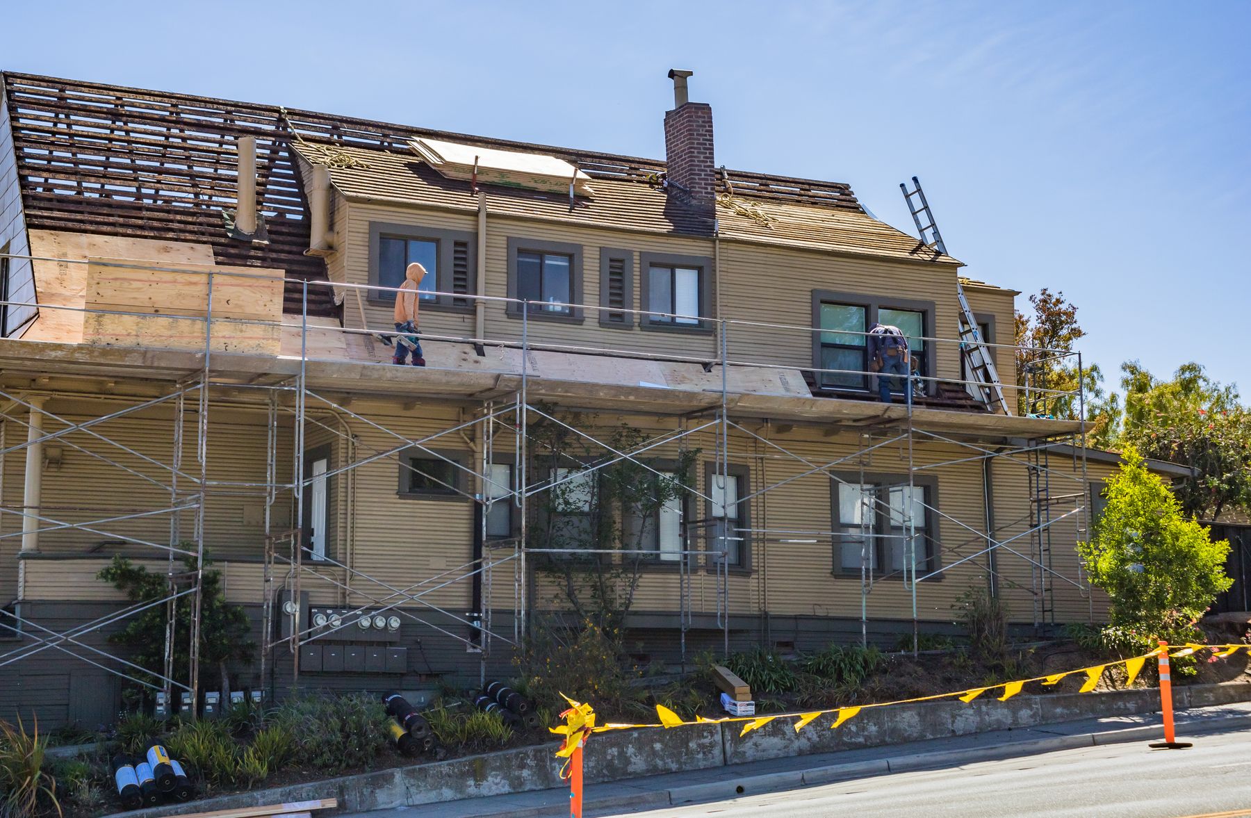 Workers repairing a family home roof