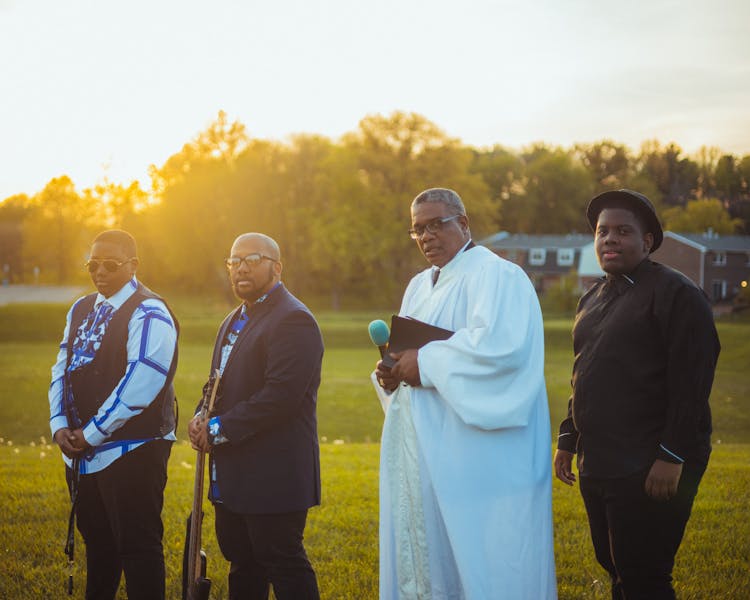 Gospels Priest And Musicians Standing In Fields