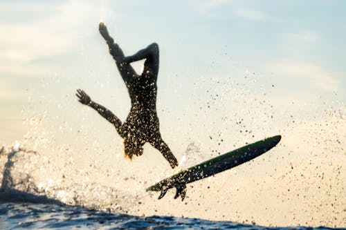 Mar Mid Air Doing a Back Flip on a Surfboard 