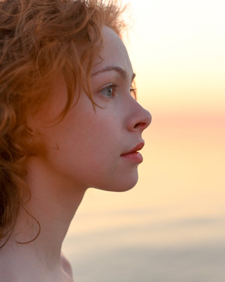 Profile View Of Young Redhead Woman At Sunset