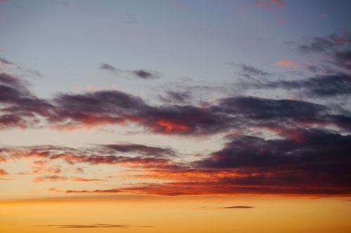 Free Tranquil scene of a sky filled with colorful clouds at sunset, creating a serene atmosphere. Stock Photo