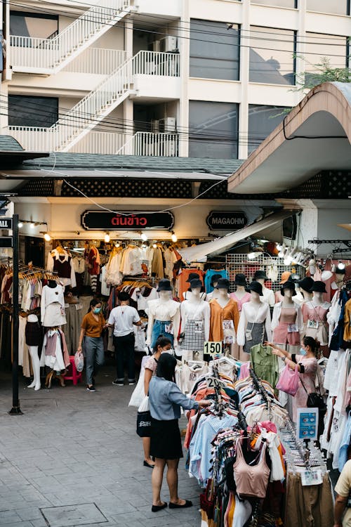 Free People Choosing Clothes Displayed on the Street Stock Photo