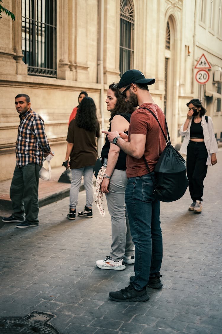 A Man Wearing A Cap While Using Smartphone