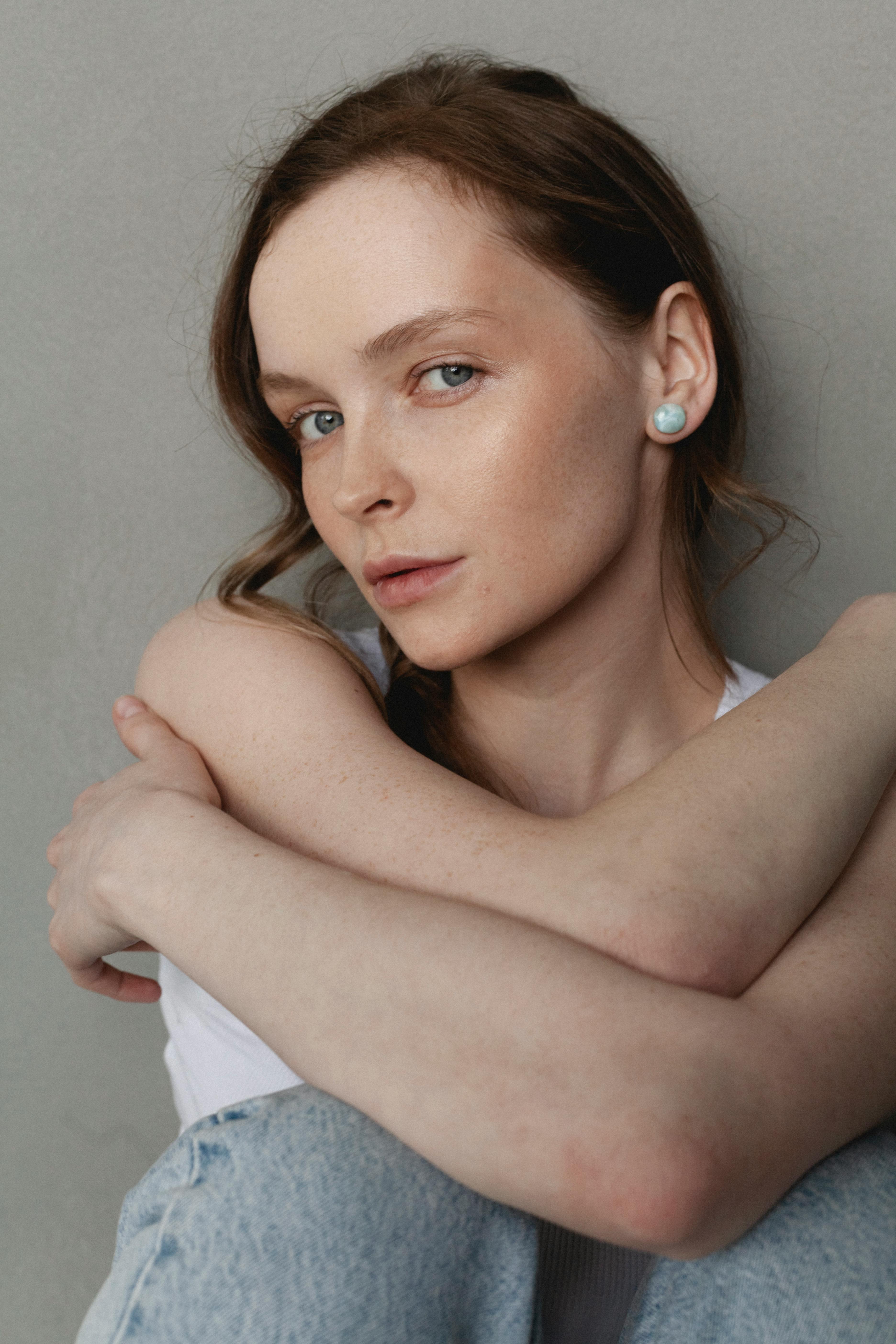 Close-up portrait of a woman with natural makeup, displaying elegance and tranquility.