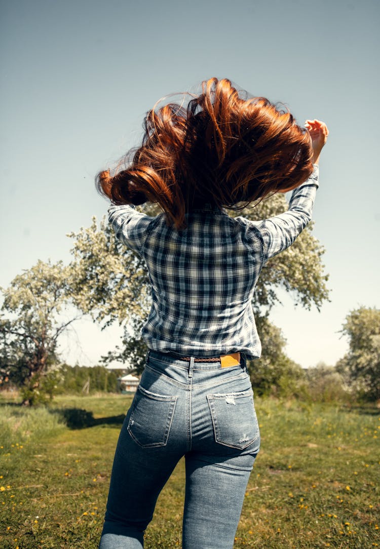 Woman In Casual Outfit Touching Hair In Park