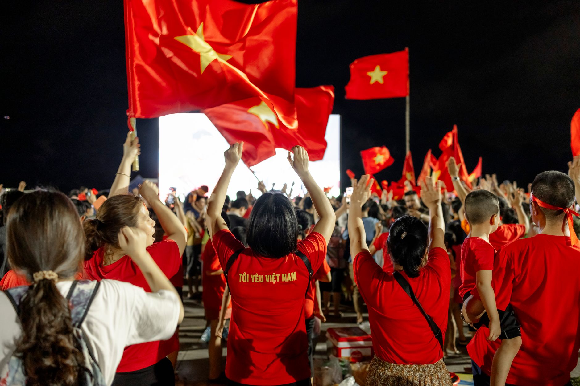 supporters waving national flags outside Mercedes-Benz Stadium during a vibrant Atlanta World Cup celebration