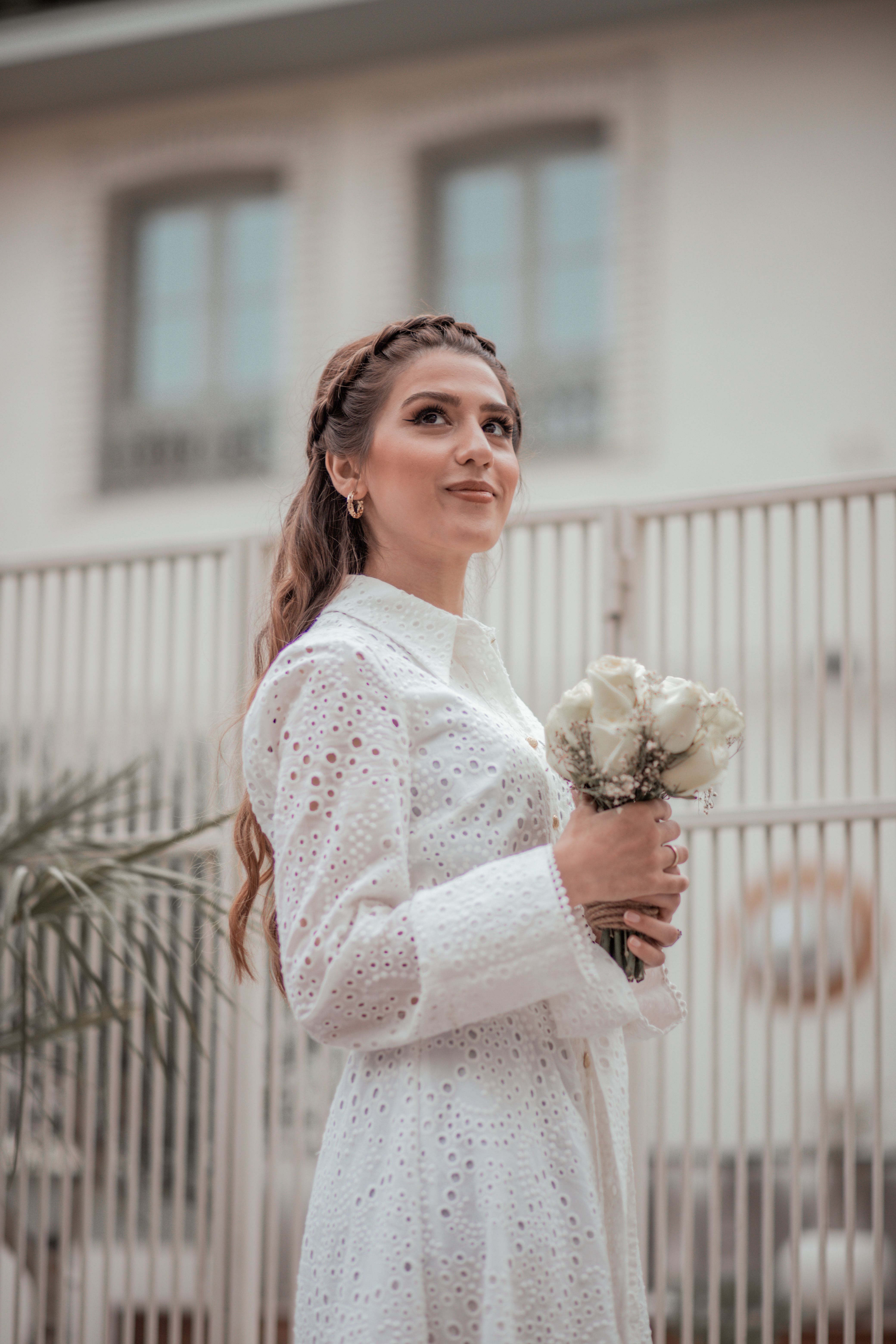 A Woman in White Dress Holding a Bouquet of Flowers · Free Stock Photo