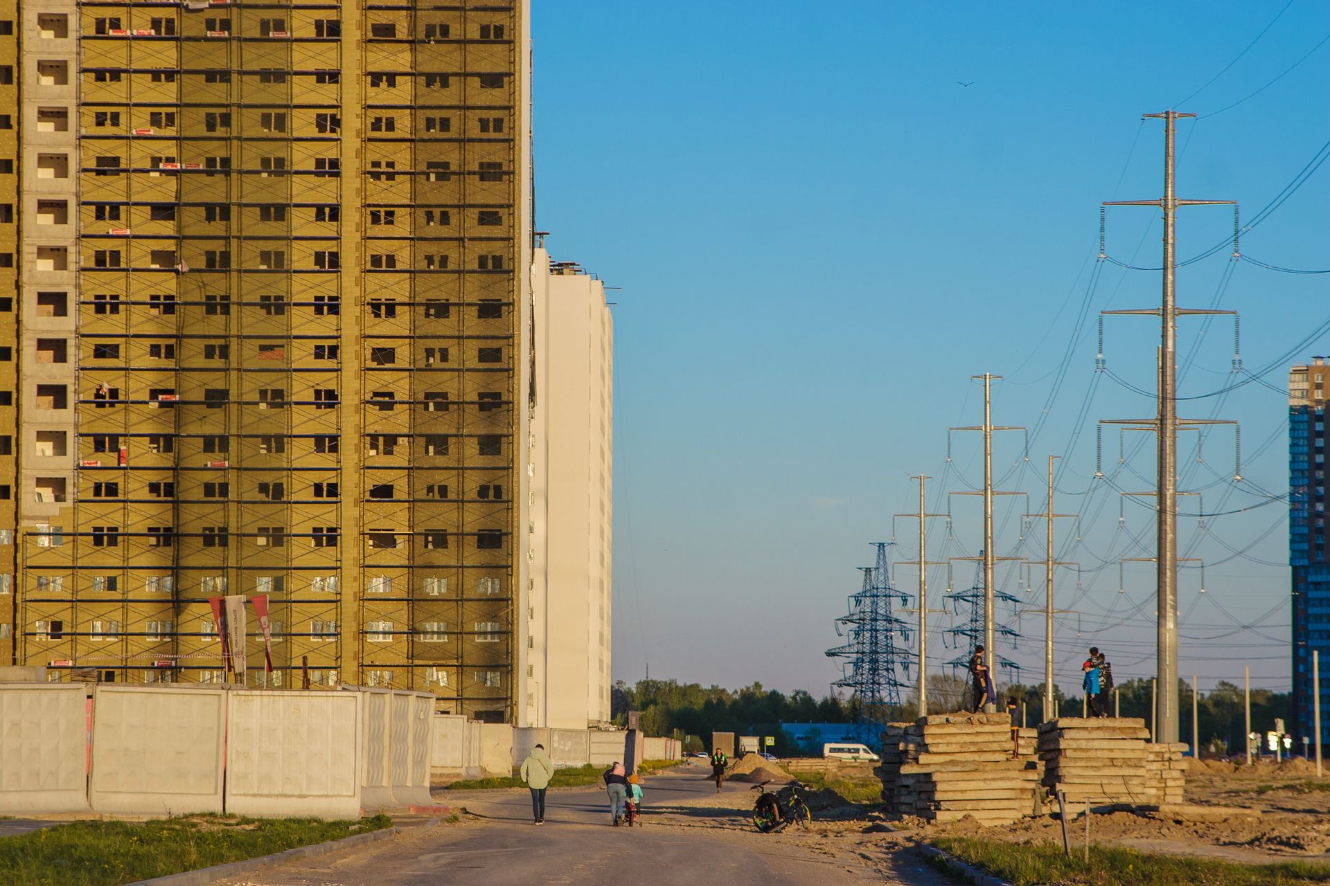 A view of high-rise buildings under construction with power lines in an urban area.