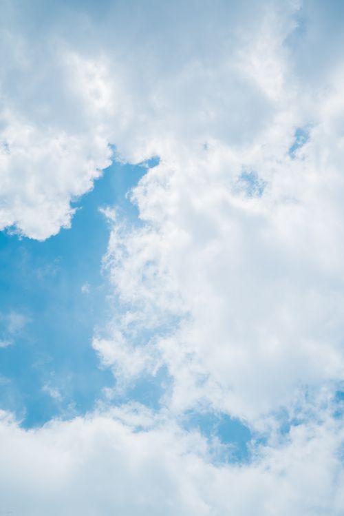 Free A beautiful capture of white fluffy clouds against a bright blue sky, showcasing the beauty of nature. Stock Photo