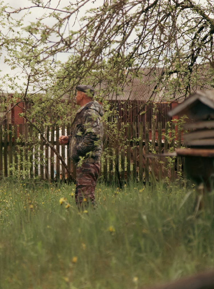 A Man Standing In A Yard