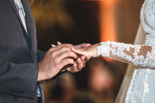 Free Close-up of a couple exchanging rings during their wedding ceremony, showcasing love and commitment. Stock Photo