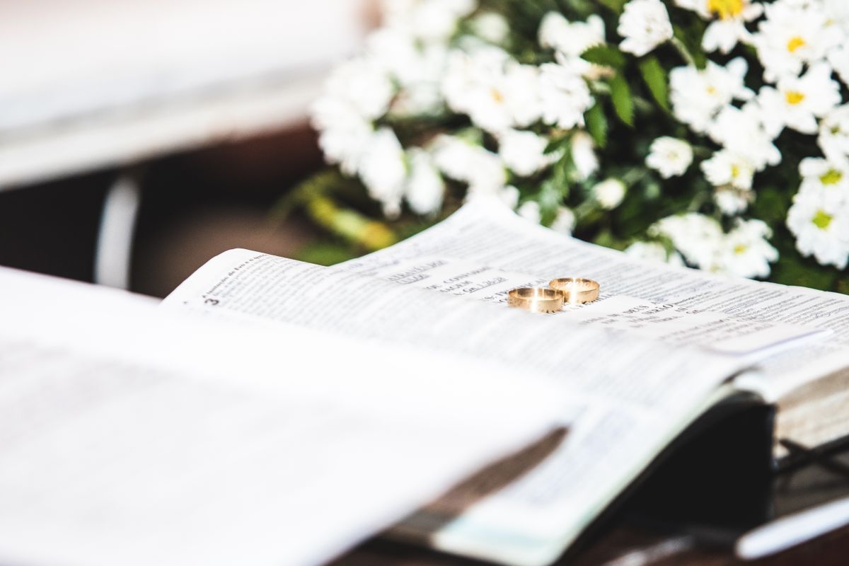 Gold rings resting on an open Bible page.