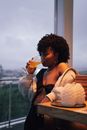 Woman in White Cardigan Holding Ice Cream Cone